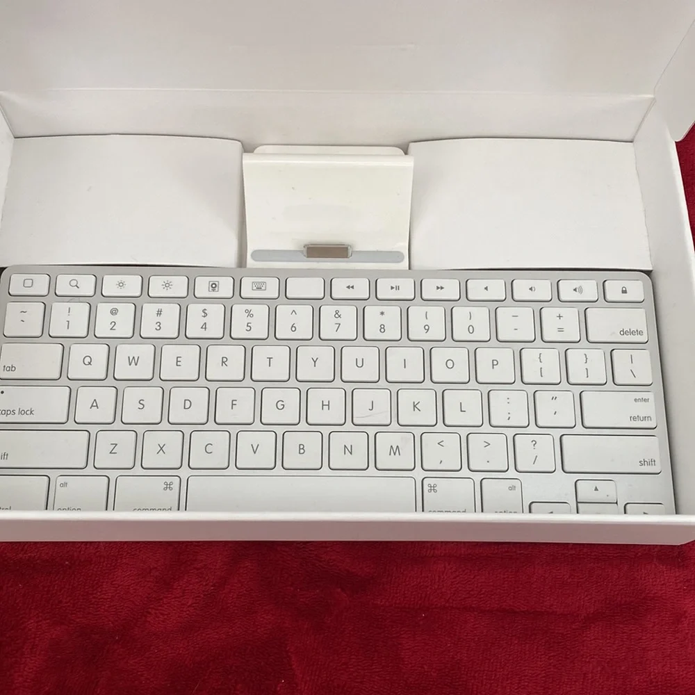 A New in Box original iPad keyboard. It has the original connector, though